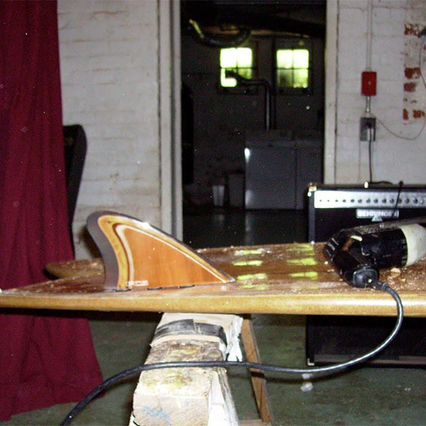 an old surf board on a sawhorse